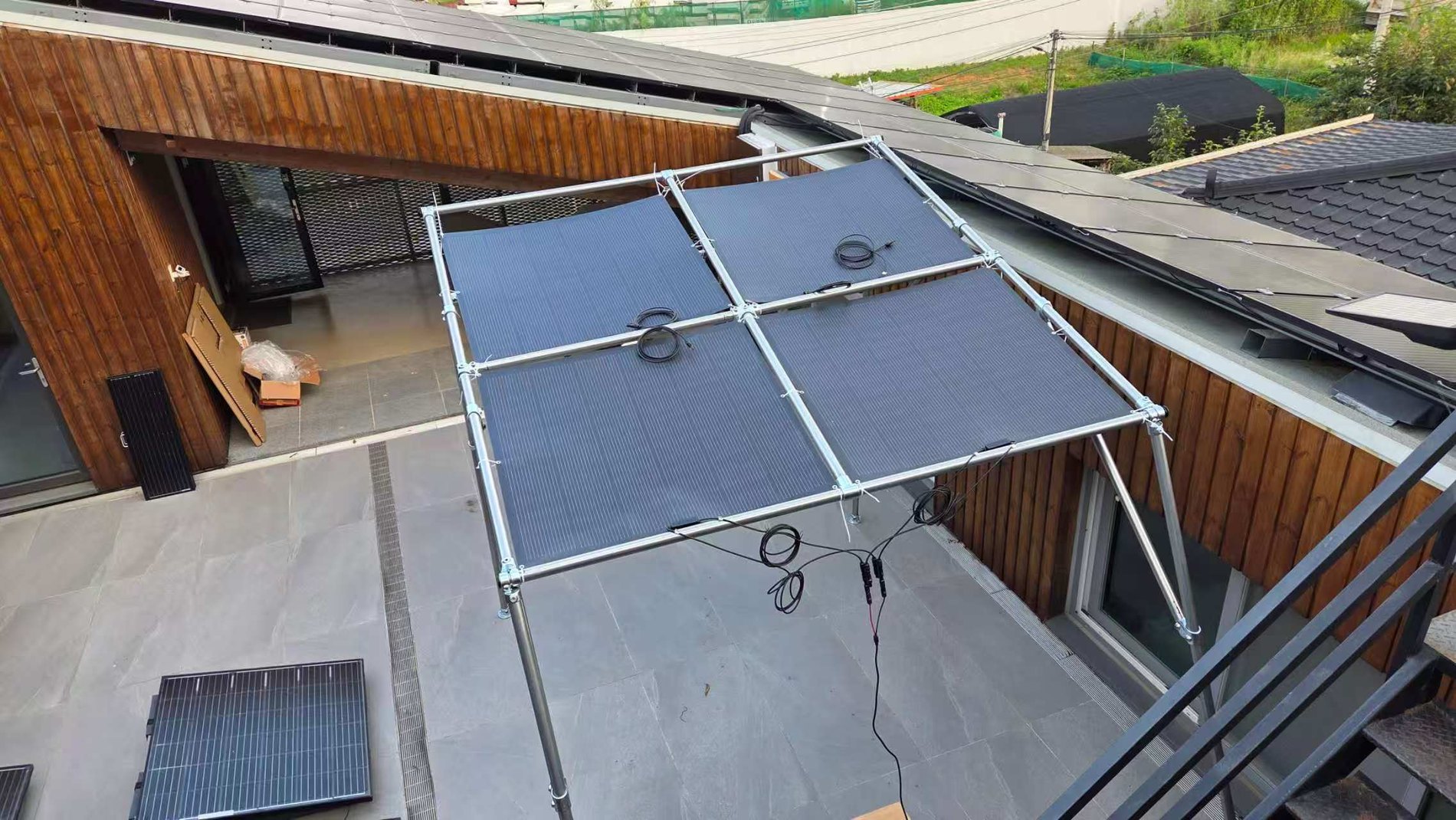 Top view of four flexible solar modules mounted on an aluminium frame with cable routing