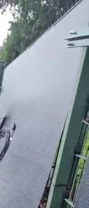 A LIONSHEE flexible solar panel being lifted onto a fence post during installation